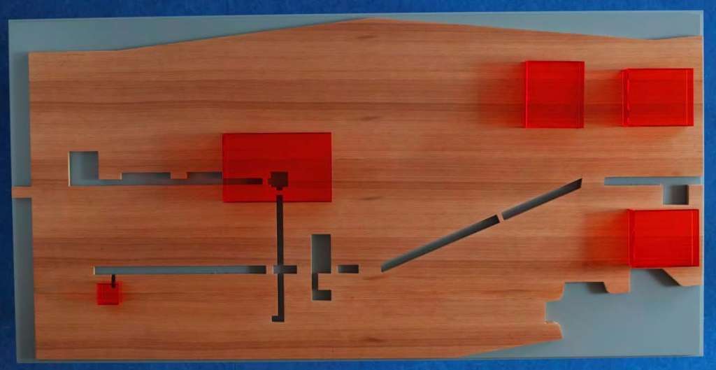 artwork of wood with plastic red pieces
