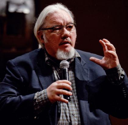 Older man talking with microphone