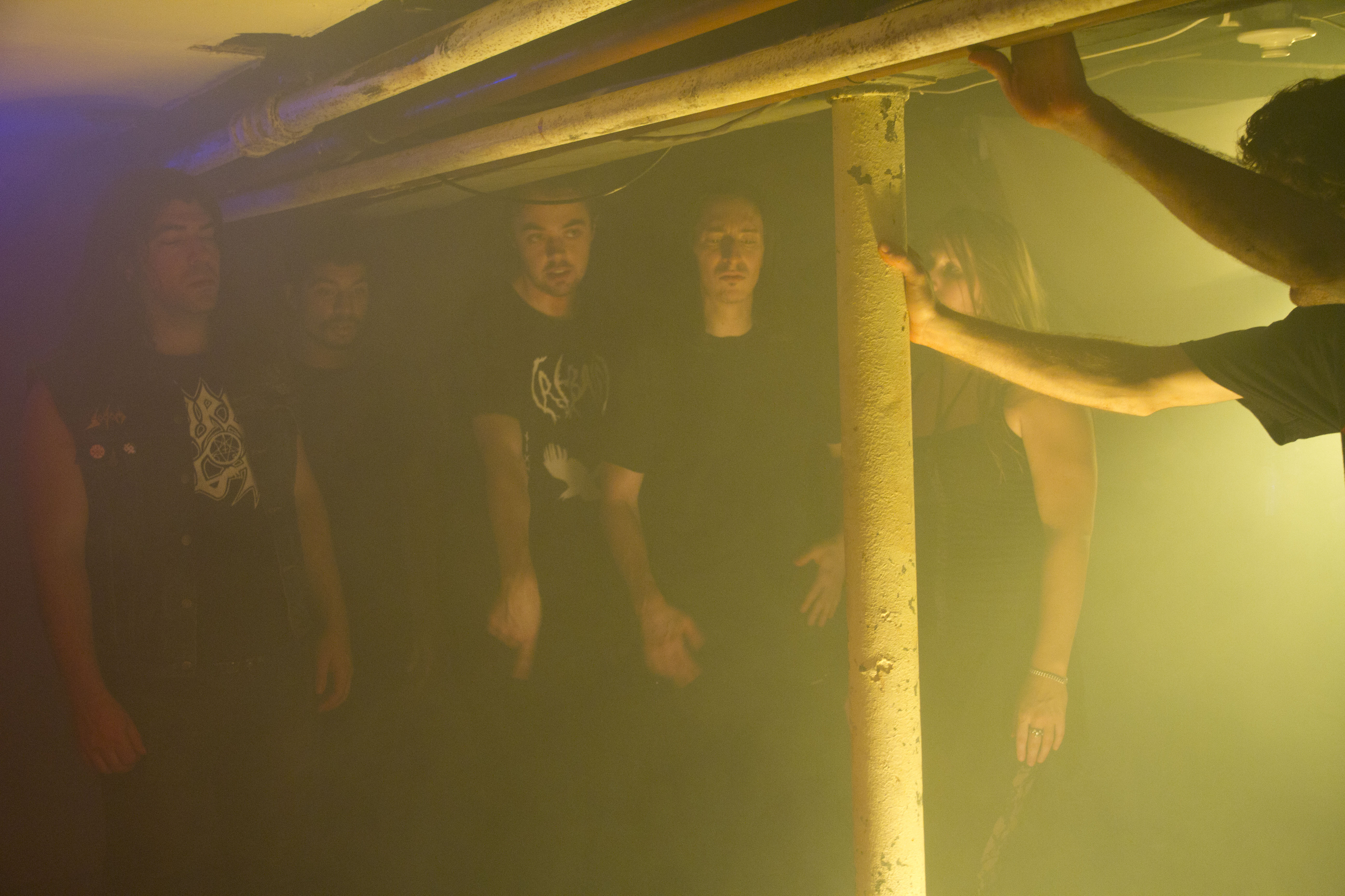 photo of young men and women in basement