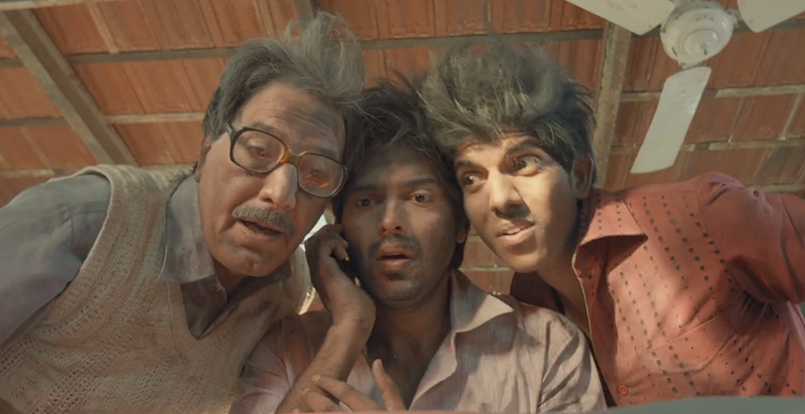 Group of Indian Men looking down at something