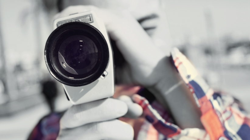 Close-up image of a person holding a camera