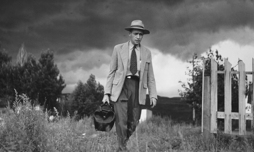 Black and white image of W. Eugene Smith walking in a field