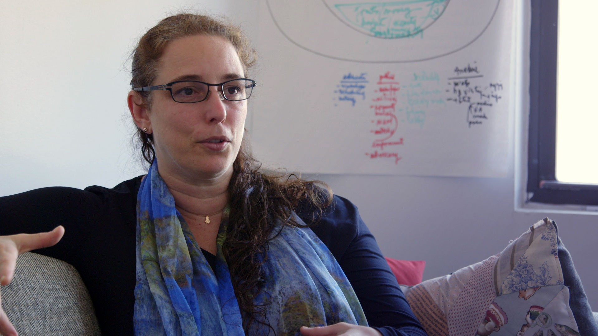Image of a woman sitting on a couch, talking