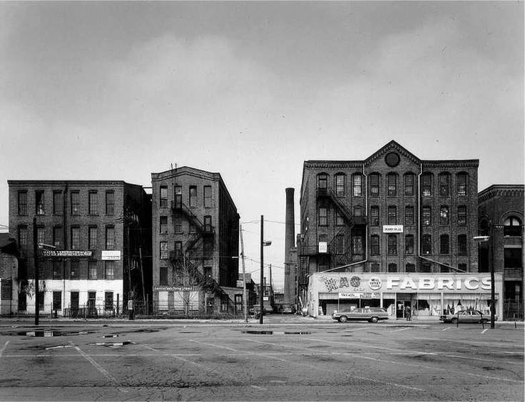 Black and white image of buildings and a empty lot
