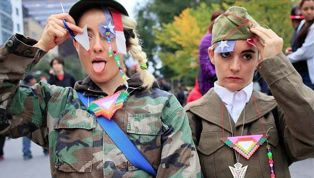 Image of two young ladies dressed in camo/uniform attires