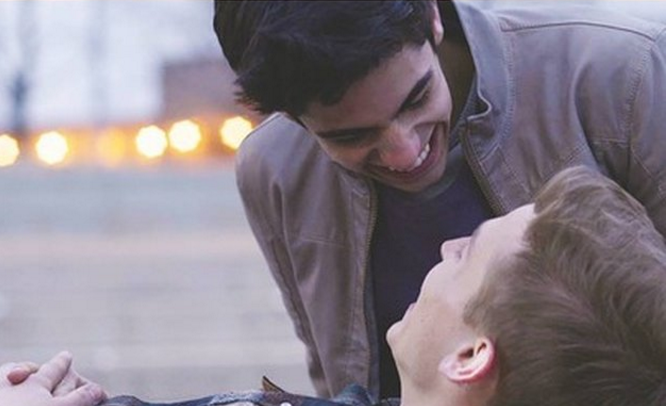 Image of two men looking at each other and smiling