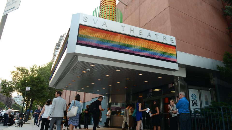 Image of the exterior of SVA Theatre with a rainbow flag on the marquee