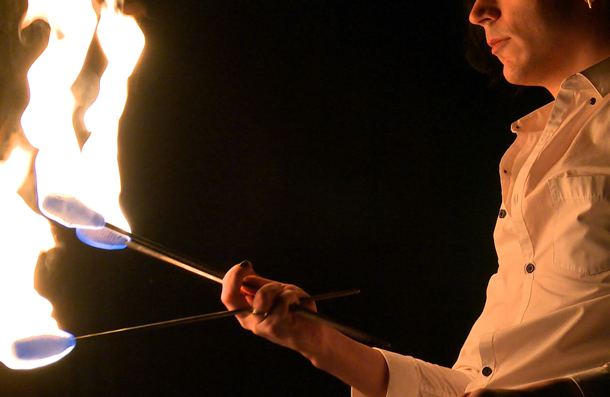 Image of a person holding flame batons