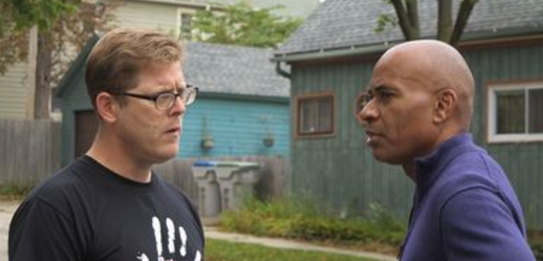 Image of two men having a conversation outside