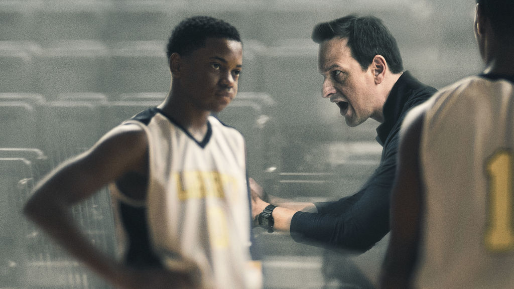 Film still of Josh Charles coaching a black high school basketball player