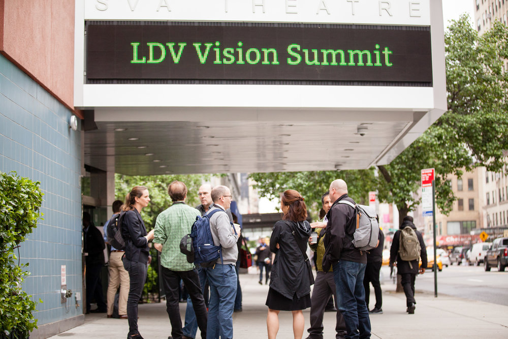 People standing outside SVA Theatre. The marquee displays "LDV Vision Summit"