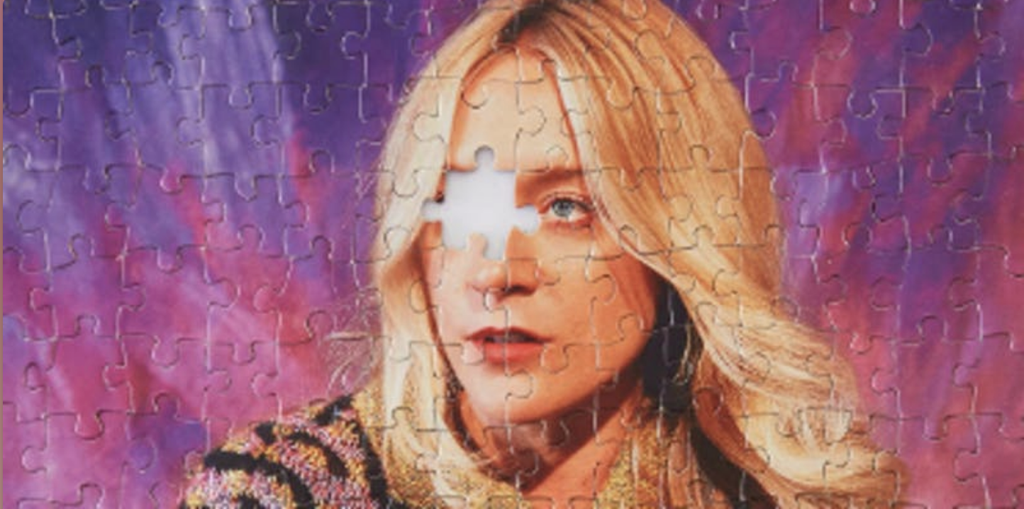 Photo of Chloe Sevigny that has been made into a jigsaw puzzle. Her right eye puzzle piece has been removed.
