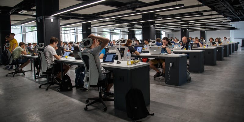People looking at their computers, working in an open office